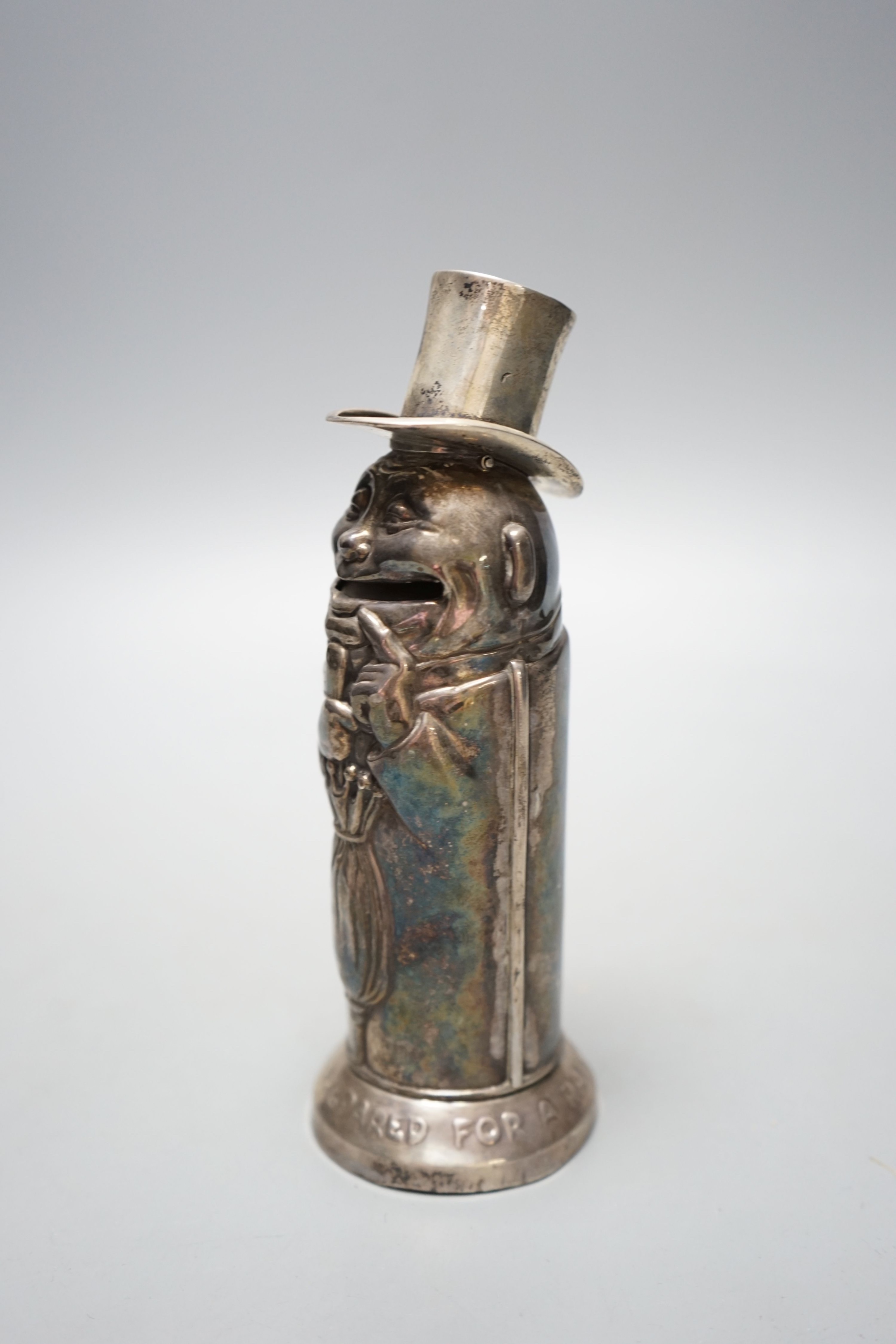 A George V silver novelty money box, embossed with a gentleman with top hat and umbrella, Birmingham, 1912, 16.9cm, inscribed 'Always be prepared for a rainy day', 107 grams.